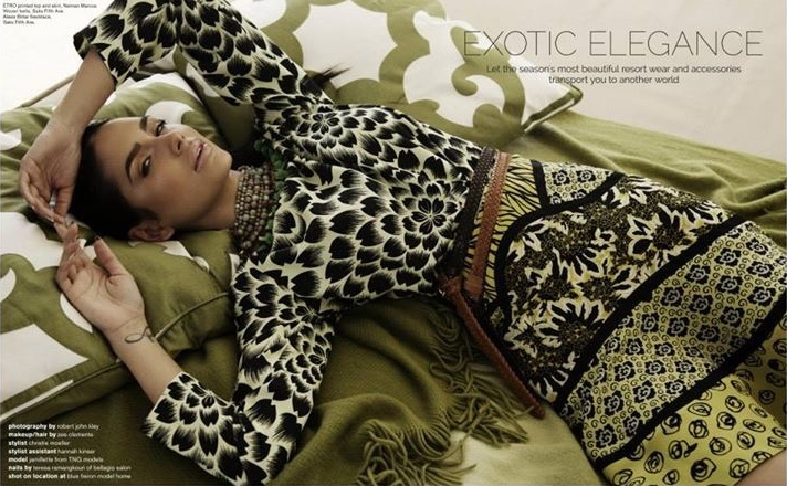 Magazine spread: Jamillette Gaxiola reclines on olive green cushions in a black and cream floral print top and patterned skirt, arms raised above her head.